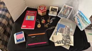 lot 1088 image: Souvenir postcards, keychains, map, buttons, cards and International travel wallet