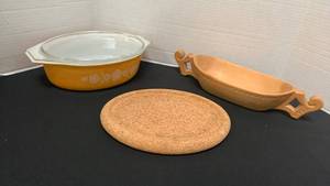 lot 1201 image: Pyrex Butterfly Gold Casserole with Lid, hand carved wooden bowl from Poland and trivet