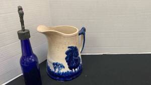 lot 1218 image: Vintage Decorative ceramic pitcher and blue glass bottle with metal stopper