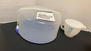 lot 1233 image: Tupperware Clear Cake Takers and measuring cup