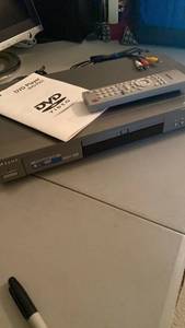 lot 1326 image: Samsung dvd player with cords and remote