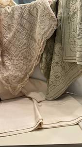 lot 1411 image: Two Square Tablecloths. And a rectangular ivory colored one, with stain.