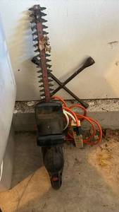 lot 3422 image: Hedge Trimmer, Electric Cords and a tire iron