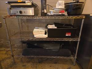 lot 20652 image: Metal Storage Shelf and Black SND 3ft X 5ft Rugs - Set of 5