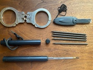 lot 26 image: Cuffs, American Warrior Knife and MORE