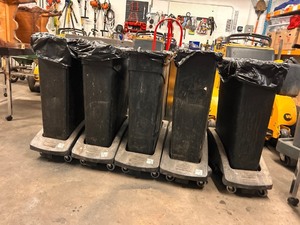 lot 354262 image: 5 Commercial Grade slim, black plastic commercial trash cans, likely the Staples Coastwide Professional Slim Plastic Trash Can mode on Rubbermaid Interlocking Wheels for easy event transport and clean up