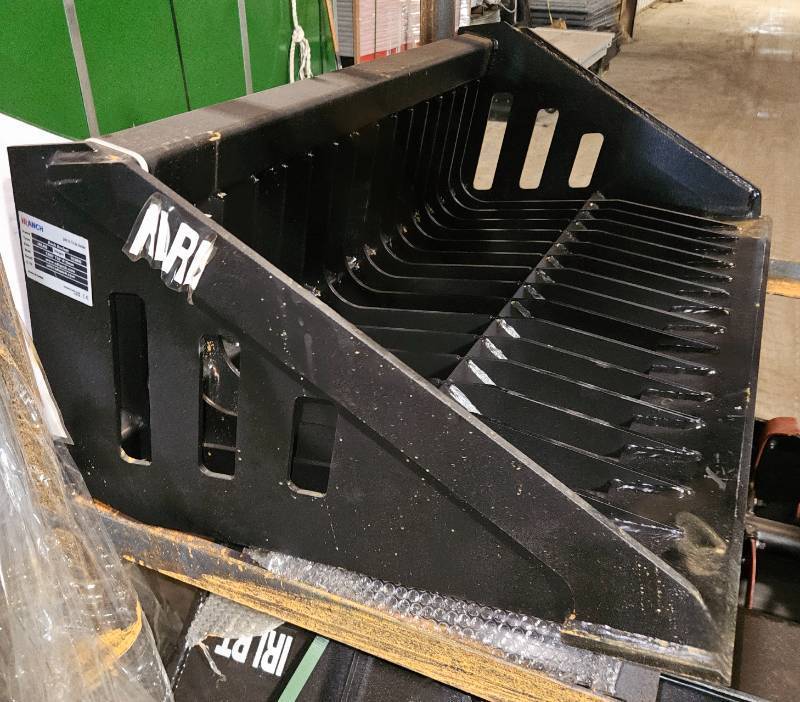 lot 5254 image: Unused 2025 IRLRB Industrial-Grade Rock Bucket Attachment Designed for Mini Skid Steer Loaders