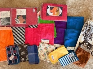 lot 203 image: Misc Vintage Linens and Aprons From Around the Kitchen, Fiesta Towels, Potato Sac and More