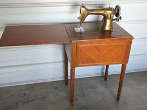 lot 24 image: New Home Light-Running Sewing Machine with Wood Cabinet