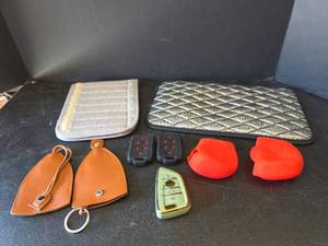 lot 563 image: Automotive Accessories Bundle - Seatbelt Cover, Armrest Cover, Key Fobs, Silicone Gear Shift Covers, and Key Chains