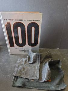 lot 762 image: Harley-Davidson 100th Anniversary Retrospective Book (no DVD) and Antelope Creek Leather Neck Warmer Size L