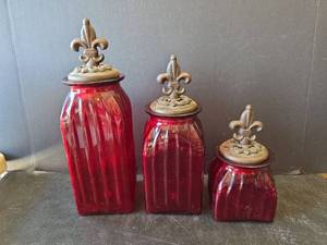 lot 791 image: Red Glass Canister Set with Fleur-de-Lis Lids