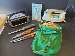 lot 845 image: Emerson Radio Alarm Clock, USB to C Charger, Knives, Iron, and Clothespins