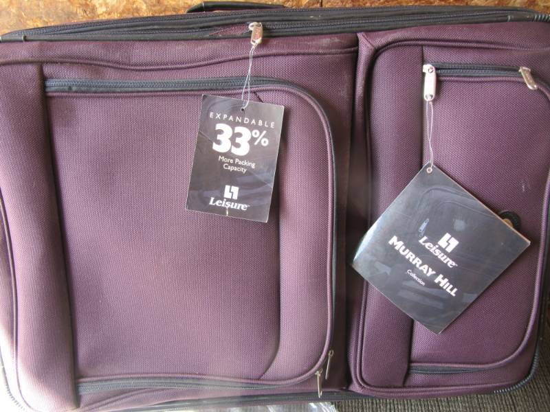 lot 306 image: 31 Burgundy Leisure expandable suitcase still has tags