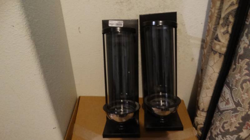 lot 1829 image: A pair of metal candle holder and glass covers.