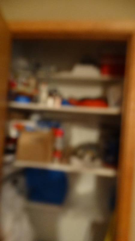 lot 1883 image: Contents on cupboard, paint, mop bucket, windex, grocery bags, etc.