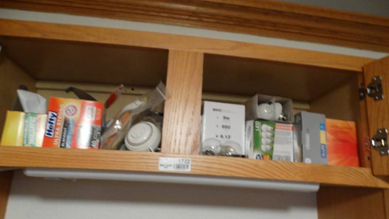lot 1722 image: Cabinet with light bulbs, trash bags, etc.