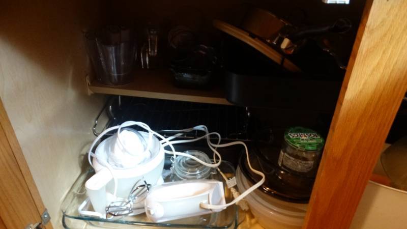 lot 1728 image: Cabinet with Hand mixer, bowls, trays, glass measuring cups, etc.