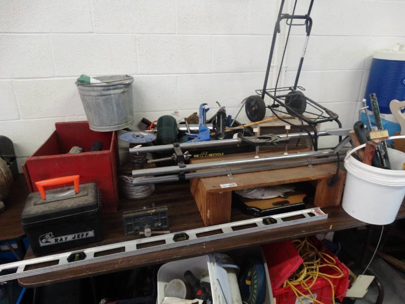 lot 7584 image: Large lot of tools, wire, caulking guns, small dolly, circular saw & more.