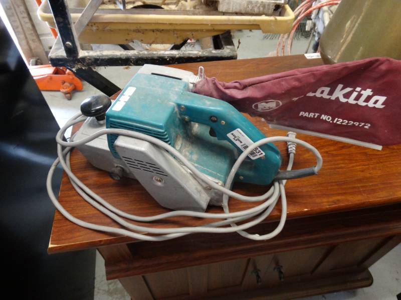 lot 7631 image: Makita belt sander.