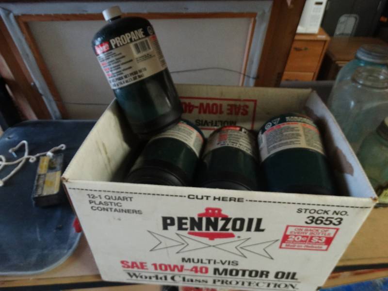 lot 7681 image: Box full of small propane bottles.