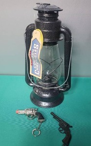 lot 149 image: Cowboy Chronicles Oil Lantern with Toy Pistol Keychain Set