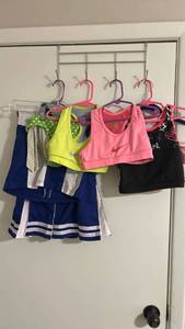 lot 206 image: Girls Athletic Wear Bundle - Nike Sports Bras, Cheer Uniform & Swimwear