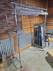 lot 7084 image: Commercial Grade Rolling Garment Rack with Clear Hangers