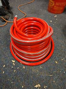 lot 7269 image: 100ft Red Heavy Duty Air Compressor Hose with Metal Fittings