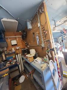 lot 2552 image: Contents of Wall and Shelf Including Porter Cable Drill, Pegboard Organization System, and More