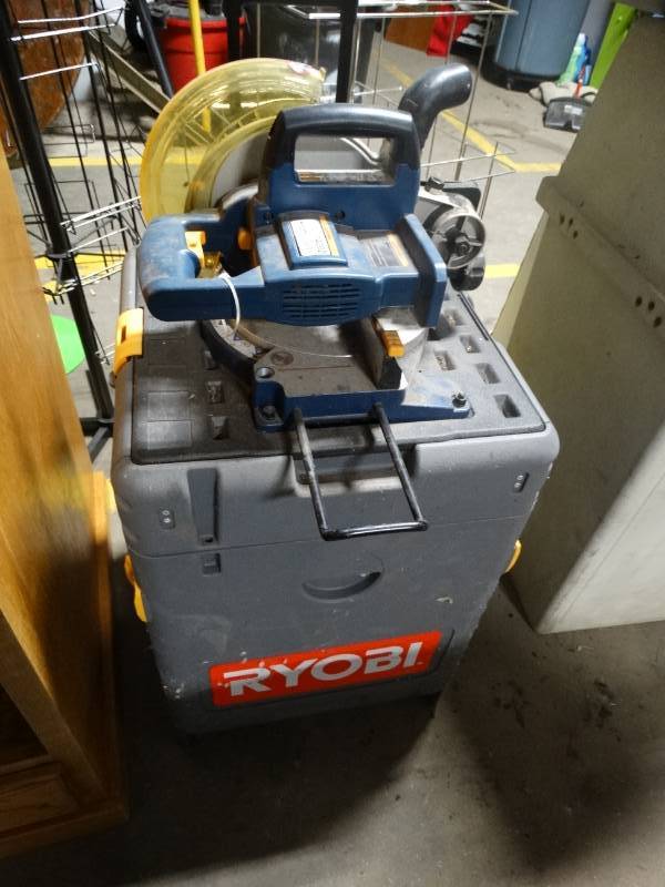 lot 14002 image: Ryobi cordless saw & other tools w stand on wheels
