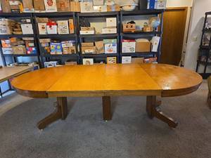 lot 68 image: Solid Oak Trestle Dining Table with Extensions and Large 54in x 108in  Clear Vinyl Table Protector