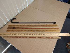 lot 465 image: Collection of Advertising Wooden Yardsticks and Metal Cane