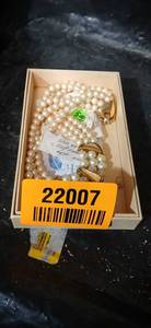 lot 22007 image: Triple Strand Pearl Necklace with Gold Bow Clasp