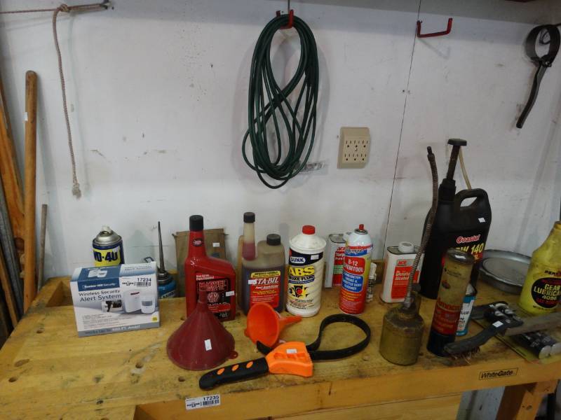 lot 17234 image: Lot of car fulids, wd-40s, funnels, oil cap removers, & more.