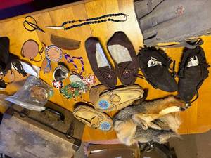 lot 1615 image: RENDEZVOUS COSTUME ITEMS, VINTAGE SUITCASE AND CONTENTS MOCCASINS, LEATHER BAG, FUR, MISC.........KCHN