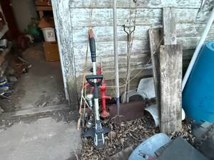 lot 1588 image: SMALL RED HAND PUMP HAYFORKOLD SNOW SHOVELWEED EATERFISHING POLES...............BY