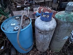 lot 1598 image: 2- 100# PROPANE BOTTLES BLUE PLASTIC BARREL