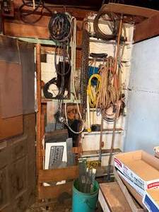 lot 1957 image: WALL OF MISC. W ROPE, COPPER WIRE, MOWER BLADES & BLADES- SHOP EW BY DOOR