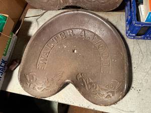 lot 1988 image: ANTIQUE CAST IRON TRACTOR SEAT (WALTER A. WOOD CORNATE)