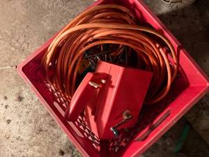 lot 2136 image: MILK CRATE OF EXTENSION CORD, FEEDER & TENT STAKES- SHOP WW