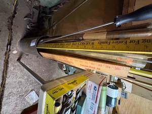 lot 1949 image: Big brass artillery shell with rods & yard sticks --  NS