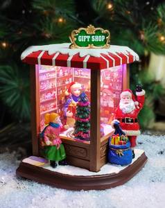 lot 13395 image: MOMENTS IN TIME Christmas Village Vintage Corner Gift Shop with Santa Claus LED Lights & Music, 8 Christmas Songs, Battery Operated, Handcrafted Polyresin Santa Figurine Holiday Decoration