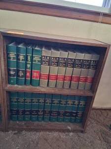 lot 23822 image: Wood Bookshelf with American Jurisprudence 2d Books 74-83, and ALR Digest to 3rd and 4th Federal