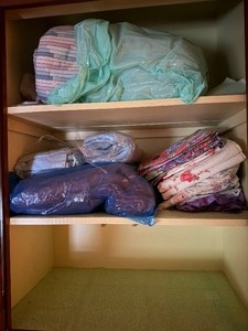 lot 24276 image: Sheet Closet with Floral Sheets and Blankets