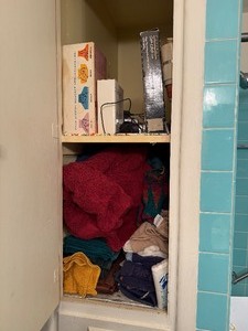 lot 24277 image: Medicine Cabinet with Towels and Misc. Hair Supplies