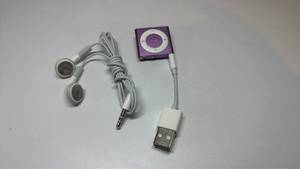 lot 18 image: Apple iPod Shuffle 4th Generation Purple with Earbuds