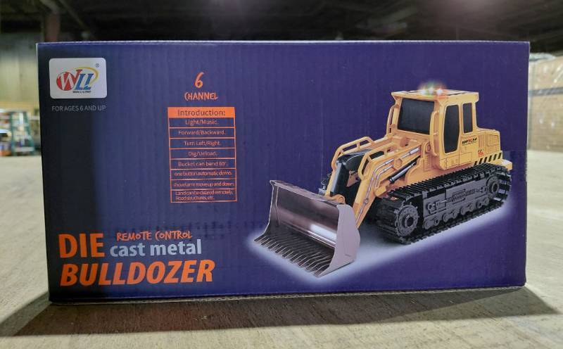 lot 5817 image: Remote Controlled Die Cast Metal Bulldozer - 6 Channel - LightMusic - ForwardBackward - Turn LeftRight - DigUnload - Bucket Can Tilt 60 Degrees - One Button Auto Demo - Shovel Move UpDown - Land Can Be Cleared Remotely, Road Structures, Etc.