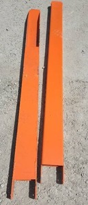 lot 3570 image: Unused Industrial Orange 7ft Forklift Extensions - Heavy-Duty Steel Forklift Extensions Designed to Increase Fork Length for Handling OversizedLonger Loads. Built with Hollow Rectangular Construction & Reinforced Mounting Brackets for Secure Fitment.