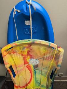 lot 1604 image: Two plastic sleds different sizes both with tow ropes